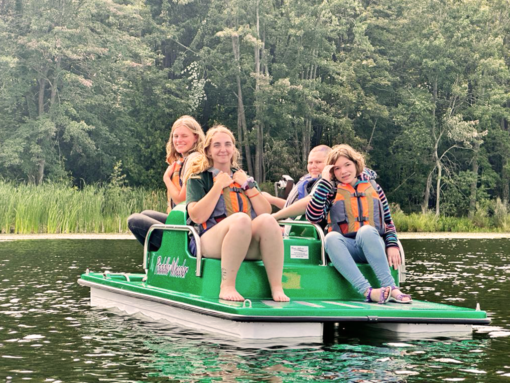 campers on a pedal boat