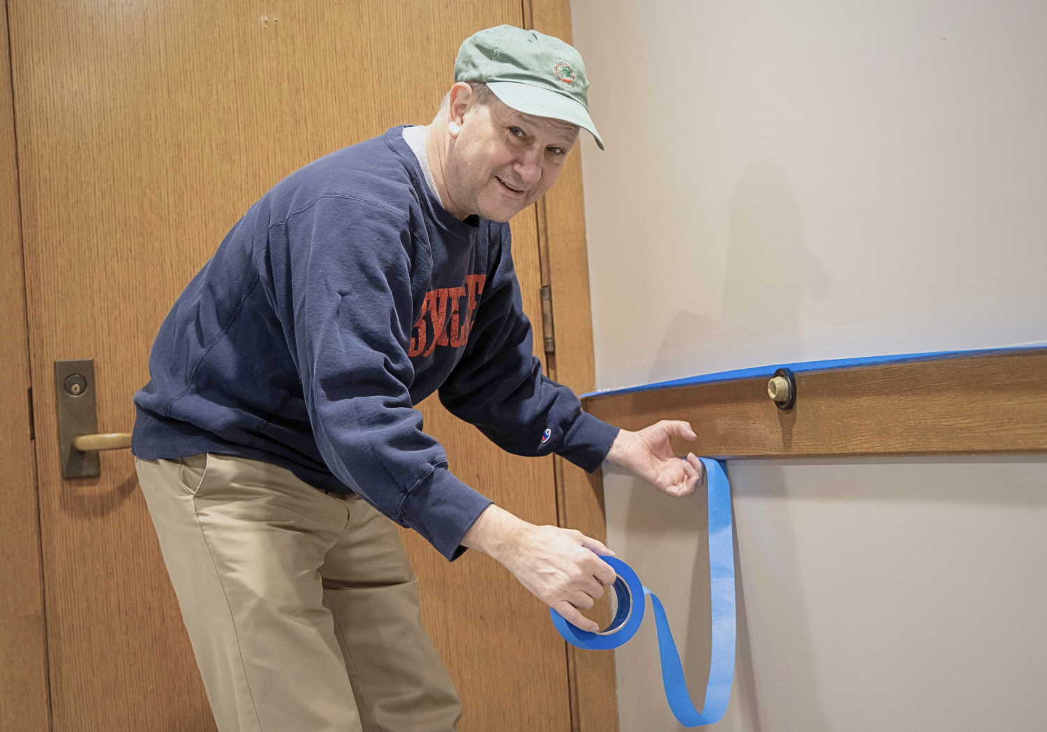 MCHS volunteer applying masking tape