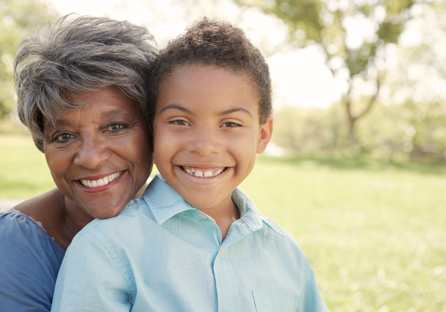 woman and young boy smiling on a sunny day